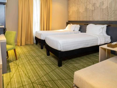 Postel nebo postele na pokoji v ubytování ibis Styles Makkah