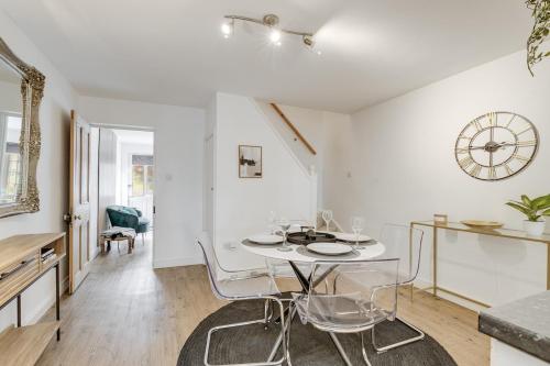 a white dining room with a white table and chairs at Riverside Cottage Retreat Hertford Town Sleeps 6 in Hertford