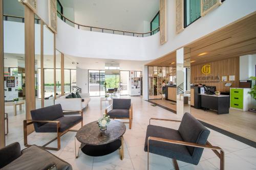 a lobby with couches and chairs and a table at 九雅集 The Nine Refined Retreats in Rawai Beach