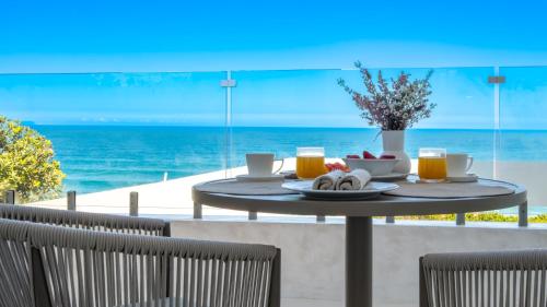 a table with a plate of food on the beach at Salt and Sand in Wilderness