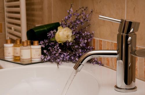 a sink with a vase of flowers on top of it at Villa Maternini in Vazzola