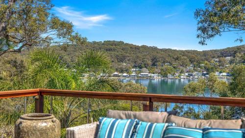 a balcony with a view of a body of water at 'Hampton Cottage' by HolidayCo in Pretty Beach