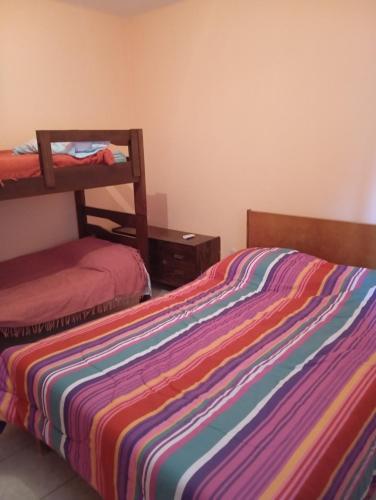 a bedroom with two beds and a bunk bed at La Rafaela in Zonda