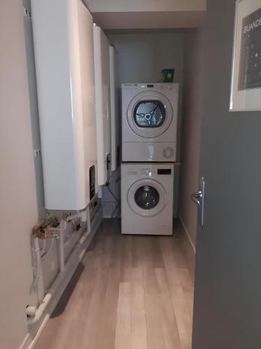 a washer and dryer in a room with a hallway at Lagnieu in Lagnieu