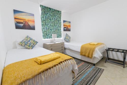 a bedroom with two beds and a window at Simla Luxury Apartments by First Private Stays in Margate