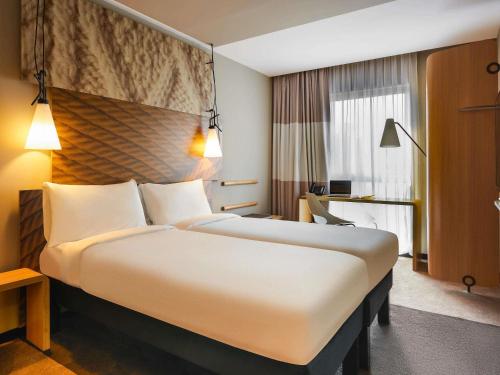 a large white bed in a hotel room at ibis Jerusalem city Center - An AccorHotels Brand in Jerusalem