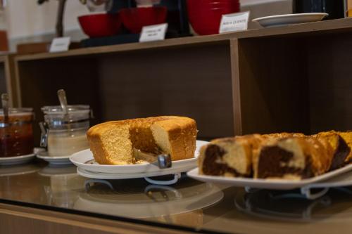 a couple of slices of cake on a counter at Scenarium Hotel in Recife