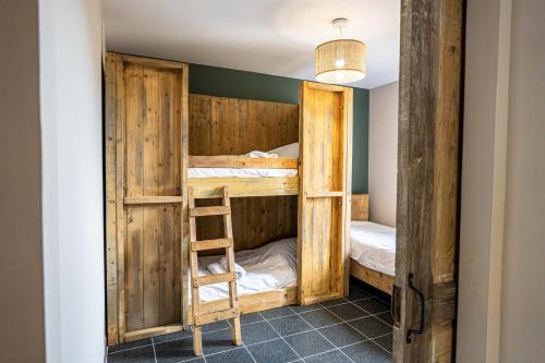 a room with two bunk beds and a ladder at Gite à la ferme, authentique & accessible PMR 