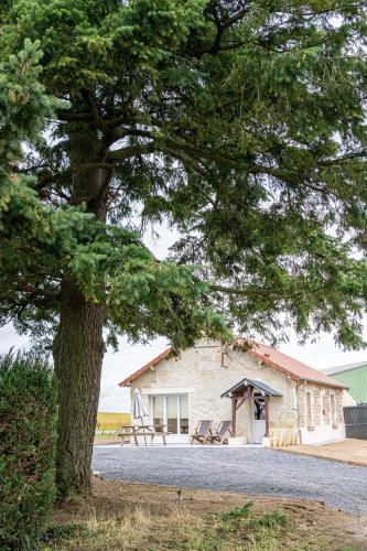 a building with a tree in front of it at Gite à la ferme, authentique & accessible PMR 