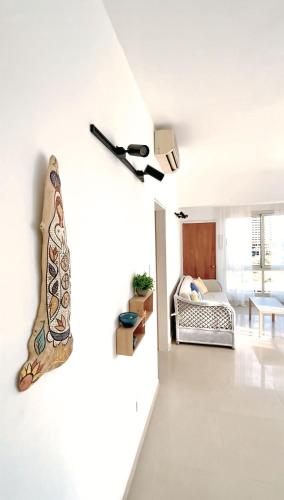 a bedroom with a bed and a flashlight on the wall at beachfront apartment with pool in Porlamar in Porlamar