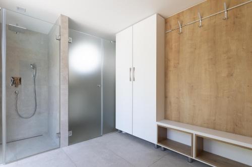 a bathroom with a shower and a walk in shower at Modern Villa Christian with pool, sauna, and jacuzzi, 10 min walk from the beach in Malinska