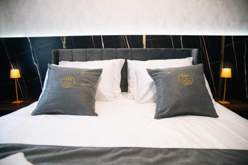 a bed with two pillows at Apartmani Residence4sisters in Zvornik