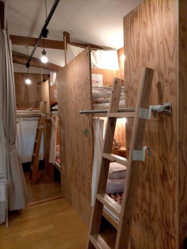 a room with a bunch of wooden walls and doors at Saga International Guesthouse Hagakure in Saga