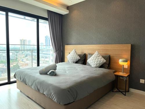 a bedroom with a large bed with a large window at Suasana Suites Johor Bahru 2 Bedroom 6pax with Pool and Free Parking in Johor Bahru