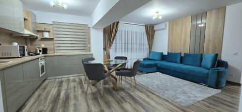 a living room with a blue couch and a table at Ultracentral Luxury in Piteşti