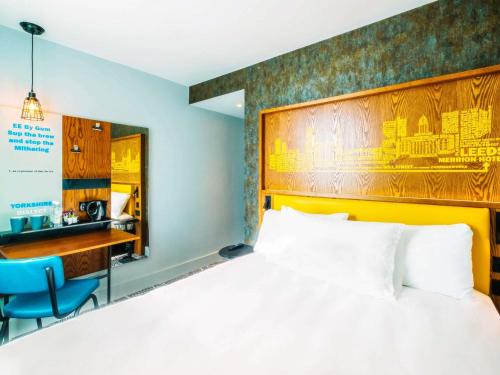 a hotel room with a bed and a desk at ibis Styles Leeds City Centre Arena in Leeds