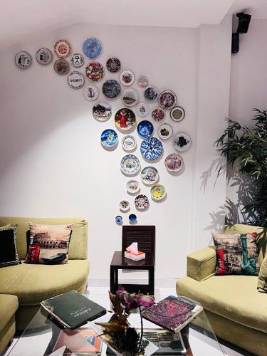 a living room with plates on the wall at Lahore Continental Hotel in Lahore
