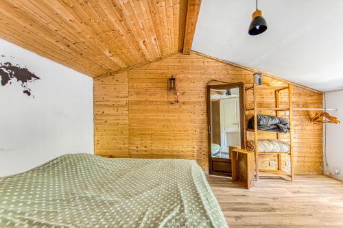 a bedroom with a bed and a mirror at Maison de Vacances d'Amélie in Saint-Germain-dʼEsteuil