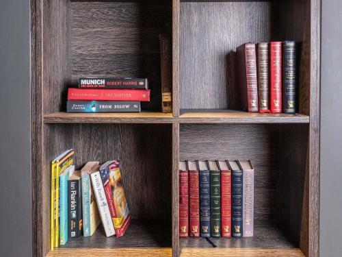 a book shelf filled with lots of books at ibis Styles Leeds City Centre Arena in Leeds