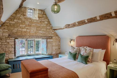 a bedroom with a large bed and a window at House of George W Davies in Broadway