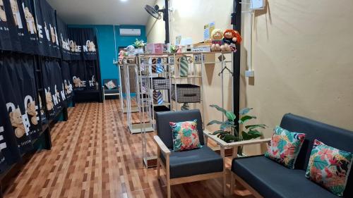 a store with two blue chairs and a room at So Cute Hostel, Kai Bae, Koh Chang in Trat