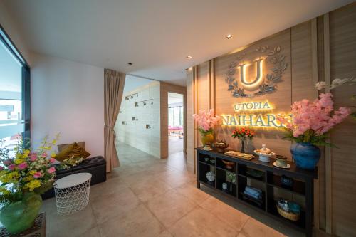 a lobby with a sign that reads yuca marauder at 九雅集 The Nine Refined Retreats in Rawai Beach