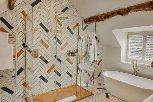 a bathroom with a shower and a tub and a sink at House of George W Davies in Broadway