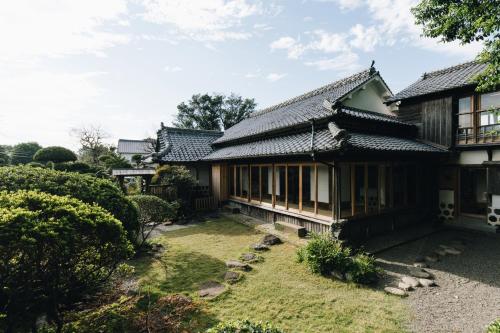 a house with a garden in front of it at RITA Izumifumoto in Izumi
