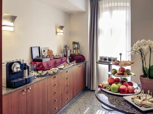 a breakfast buffet in a hotel room with fruits and food at Mercure Hotel München Airport Freising in Freising