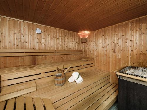 a wooden sauna with two towels in it at Mercure Hotel München Airport Freising in Freising