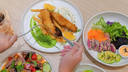 a table with four plates of food on it at Holiday Inn Pattaya by IHG in Pattaya Central
