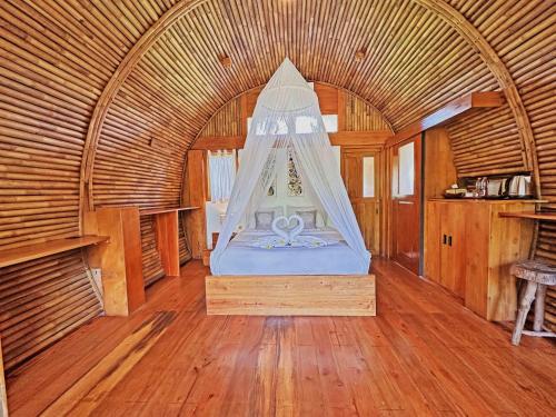 a bedroom with a bed in a bamboo room at Lagoona Beach Bungalows - Eco Bungalows Batukaras in Batukaras