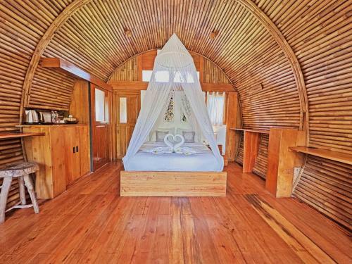 a bedroom with a bed in a bamboo room at Lagoona Beach Bungalows - Eco Bungalows Batukaras in Batukaras