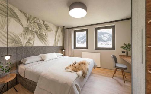 a bedroom with a dog laying on a bed at Carpe Solem Kaprun 4 star superior Hotel by ALPS RESORTS in Kaprun
