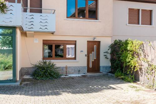 a house with a door in front of it at Au Bretzel in Ostheim