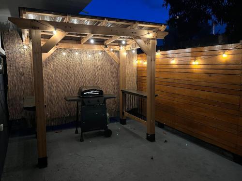 a wooden fence with a grill under a pergola at Oceanfront 5BR Oasis w Decks & Direct Beach Access in Mayaguez
