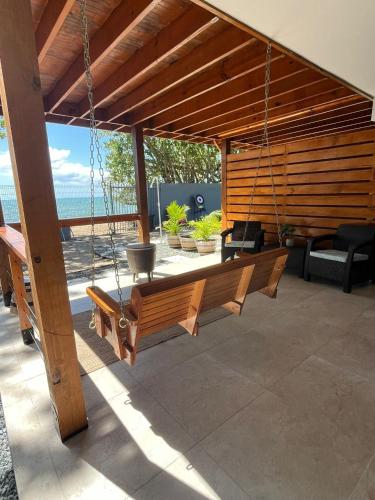 a swing in a porch with a view of the ocean at Oceanfront 5BR Oasis w Decks & Direct Beach Access in Mayaguez