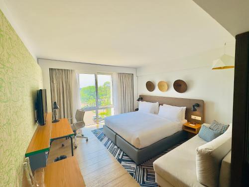 a hotel room with a bed and a couch at Holiday Inn - Lusaka by IHG in Lusaka