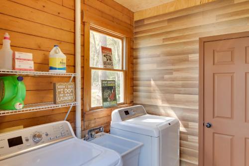 a laundry room with a washer and dryer in a cabin at Lake Broward Cabin with Private Boat Launch and Dock! in Satsuma