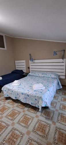 a bedroom with a bed and a tile floor at Il Posticino in Laurino