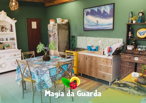 パリョサにあるPousada Magia da Guardaのテーブルと冷蔵庫のあるキッチン