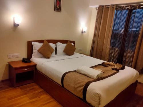 a bedroom with a large bed with a night stand at Parasol Norling Hotel & Spa in Jāmb
