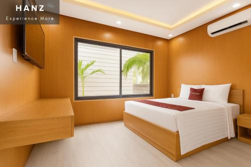 a bedroom with a bed and a window at S79 Phu Van Aires Beach Bungalow in Phu Quoc