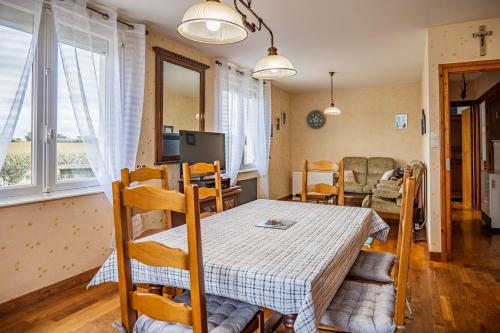 a kitchen and dining room with a table and chairs at Authentic Ty Parc Hamon in Ploujean