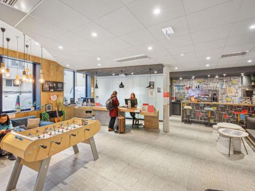 a store with a table in the middle of a room at ibis Saint Germain en Laye Centre in Saint-Germain-en-Laye