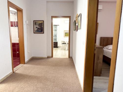 a hallway leading to a room with a bed and a bedroom at Shkodra Apartments in Shkodër