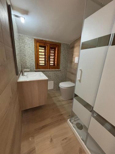 a bathroom with a sink and a toilet at White Moon in Fontane Bianche