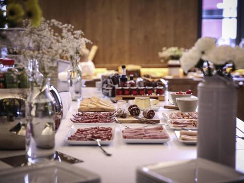 a long table with plates of food on it at Novotel Saint Brieuc Centre Gare in Saint-Brieuc