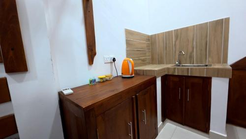 a small kitchen with a wooden counter and a sink at Meegahapokuna Resort in Anuradhapura
