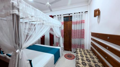 a bedroom with a bed with a canopy at Meegahapokuna Resort in Anuradhapura